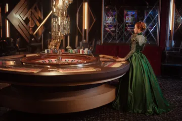 A man celebrating a winning moment on his laptop while gaming symbols float around him, capturing the excitement of 3666BEF games.